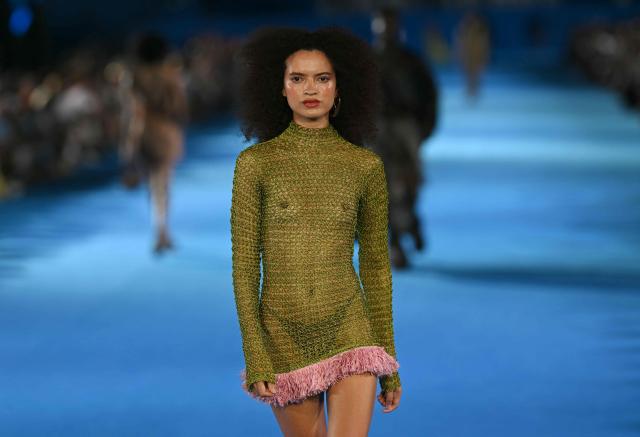 A model presents a creation by Misci during Rio Fashion Week at Marques de Sapucai sambadrome in Rio de Janeiro, Brazil on April 17, 2026. (Photo by Mauro PIMENTEL / AFP)