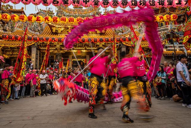 Dragon dancers perform in front of a temple during the annual Dajia Mazu Pilgrimage event in Taichung on April 17, 2026. (Photo by Cheng-Chia Huang / AFP)