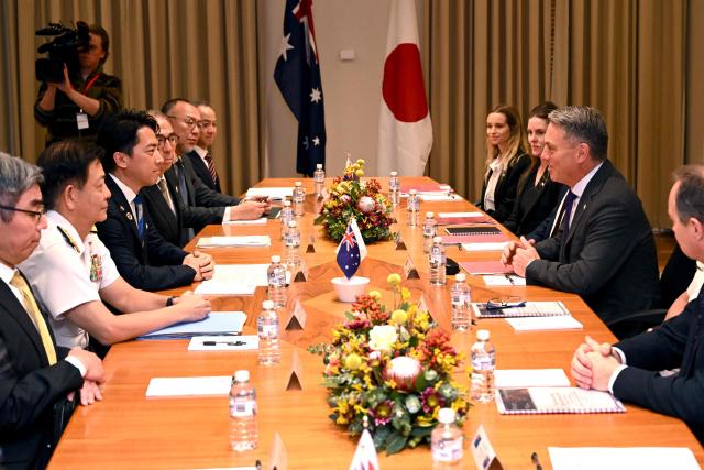 Australia's Deputy Prime Minister and Minister for Defence Richard Marles (2nd R) speaks with Japan's Minister of Defense Koizumi Shinjiro (3rd L) during a Defence Ministers' Meeting at the Commonwealth Parliament Offices in Melbourne on April 18, 2026. Japan has agreed on a deal to provide Australia's navy with the first of almost a dozen stealth frigates, part of a wider military build up by Canberra aimed at boosting its long-range firepower to deter China. (Photo by William WEST / AFP)