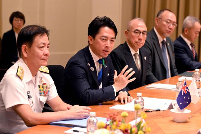 Japan's Minister of Defense Koizumi Shinjiro (2nd L) speaks with Australia's Deputy Prime Minister and Minister for Defence Richard Marles (not pictured) during a Defence Ministers' Meeting at the Commonwealth Parliament Offices in Melbourne on April 18, 2026. Japan has agreed on a deal to provide Australia's navy with the first of almost a dozen stealth frigates, part of a wider military build up by Canberra aimed at boosting its long-range firepower to deter China. (Photo by William WEST / AFP)