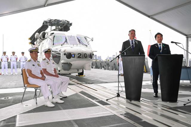 Australia's Deputy Prime Minister and Minister for Defence Richard Marles (2nd R) and Japan's Minister of Defense Koizumi Shinjiro (R) speak during a press conference after signing a contract for Japan to deliver the first three of Mogami-class warships, in Melbourne on April 18, 2026. Japan agreed on April 18 on a deal to provide Australia's navy with the first of almost a dozen stealth frigates, part of a wider military build up by Canberra aimed at boosting its long-range firepower to deter China. (Photo by William WEST / AFP)