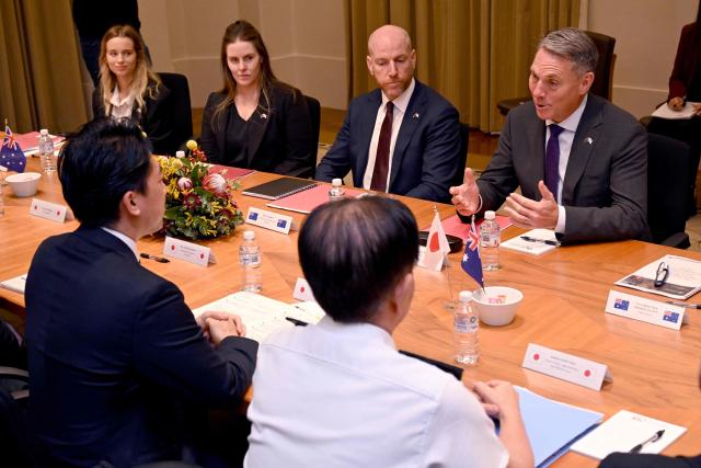 Australia's Deputy Prime Minister and Minister for Defence Richard Marles (R) speaks with Japan's Minister of Defense Koizumi Shinjiro (L) during a Defence Ministers' Meeting at the Commonwealth Parliament Offices in Melbourne on April 18, 2026. Japan has agreed on a deal to provide Australia's navy with the first of almost a dozen stealth frigates, part of a wider military build up by Canberra aimed at boosting its long-range firepower to deter China. (Photo by William WEST / AFP)