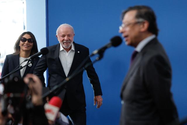 Brazilian President Luiz Inacio Lula da Silva arrives with his wife Rosangela Lula da Silva (L) as Colombian President Gustavo Petro speaks to reporters before a "Meeting in Defence of Democracy", a meeting of leftist leaders seeking to rally against the threat to democracy from the far right in Barcelona on April 18, 2026. The gathering comes as democratic institutions and values have faced growing threats around the globe from advancing authoritarian and far-right forces in the age of US President Donald Trump.
Many of the participants will take part in the first edition of the so-called "Global Progressive Mobilisation" which will be held in the same venue. (Photo by Oscar DEL POZO / AFP)
