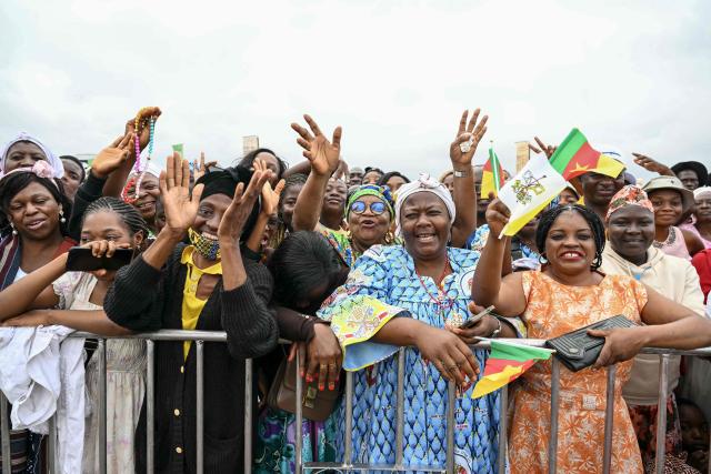 Faithfuls gather ahead of the arrival of Pope Leo XIV to lead a Holy Mass at the Yaounde Ville Airport in Yaounde on the sixth day of an 11-day apostolic journey to Africa, on April 18, 2026. (Photo by Alberto PIZZOLI / AFP)