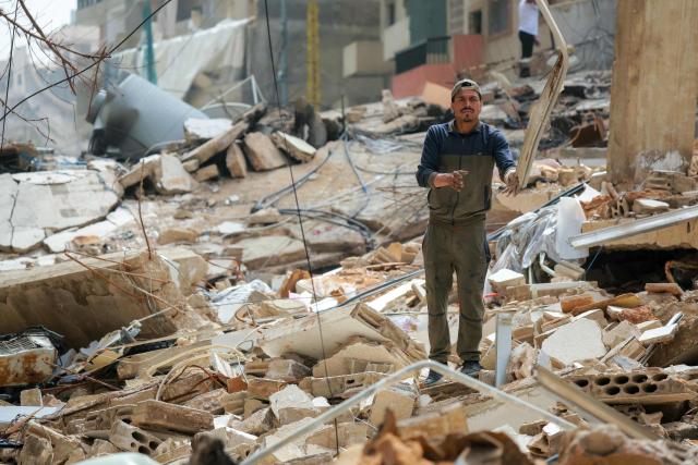A displaced clears the rubble of damaged buildings as residents return to their homes in Beirut’s southern suburbs on April 18, 2026. Israel and Lebanon agreed to a 10-day ceasefire on April 16 in order to negotiate an end to six weeks of war between Israel and the Iran-backed group Hezbollah. The conflict saw massive Israeli airstrikes across Lebanon and also a ground invasion in the south. (Photo by ibrahim AMRO / AFP)