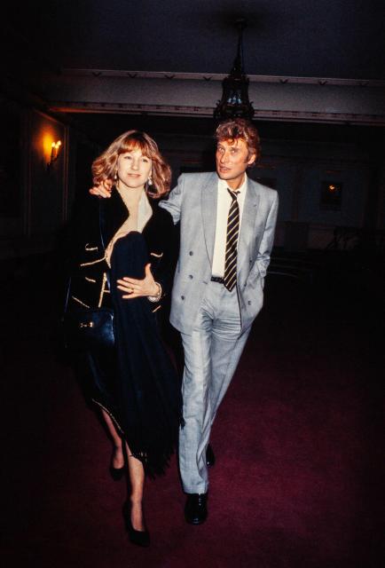 (FILES) French actress Nathalie Baye and singer Johnny Hallyday leave the Theatre Edouard VII, in Paris on February 14, 1984. Nathalie Baye, 77, passed away on April 17, 2026, announced her family to Agence France-Presse on April 18, 2026. (Photo by AFP)