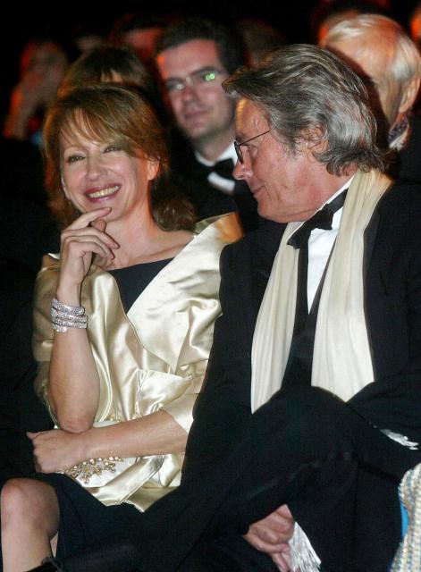 (FILES) French actor Alain Delon (R) speaks with French actress Nathalie Baye during a tribute ceremony dedicated to French producer Daniel Toscan du Plantier during the Marrakech Film Festival at the Badii palace of Marrakech on October 4, 2003. Nathalie Baye, 77, passed away on April 17, 2026, announced her family to Agence France-Presse on April 18, 2026. (Photo by ABDELHAK SENNA / AFP)