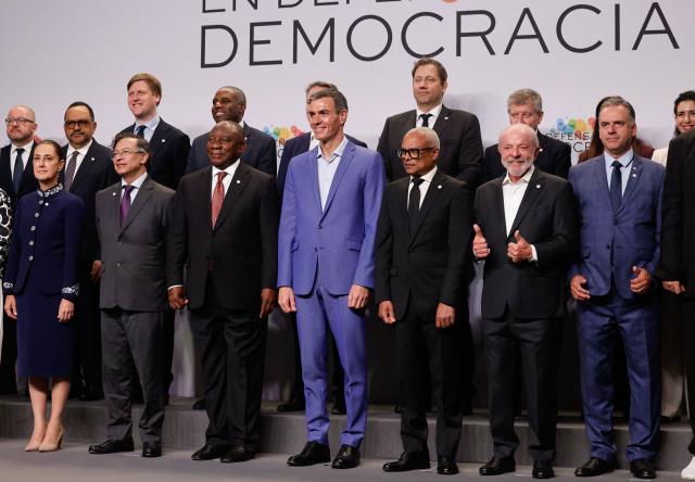 (From L front row) Mexico's President Claudia Sheinbaum, Colombia's President Gustavo Petro, South Africa's President Cyril Ramaphosa, Spain's Prime Minister Pedro Sanchez, Cape Verde's President Jose Maria Neves, Brazilian President Luiz Inacio Lula Da Silva,  and Uruguay's President Yamandu Orsi pose for a family photo at a "Meeting in Defence of Democracy", a meeting of leftist leaders seeking to rally against the threat to democracy from the far right in Barcelona on April 18, 2026. The gathering comes as democratic institutions and values have faced growing threats around the globe from advancing authoritarian and far-right forces in the age of US President Donald Trump. Many of the participants will take part in the first edition of the so-called "Global Progressive Mobilisation" which will be held in the same venue. (Photo by Oscar DEL POZO / AFP)