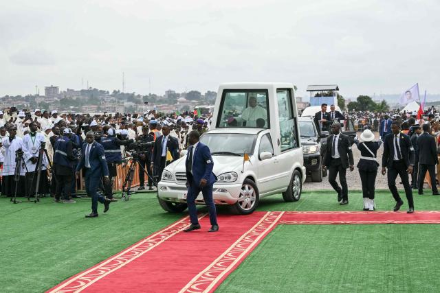 Pope Leo XIV (C) arrives in the Popemobile to lead a Holy Mass at the Yaounde Ville Airport in Yaounde on the sixth day of an 11-day apostolic journey to Africa, on April 18, 2026. (Photo by Alberto PIZZOLI / AFP)
