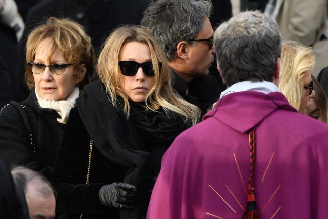 (FILES) French actress and former wife of late French singer Johnny Hallyday Nathalie Baye (2nd L) and daughter of late French singer Johnny Hallyday Laura Smet (L) stand outside the La Madeleine Church at the end of the funeral ceremony in tribute to late French singer Johnny Hallyday in Paris on December 9, 2017. Nathalie Baye, 77, passed away on April 17, 2026, announced her family to Agence France-Presse on April 18, 2026. (Photo by BERTRAND GUAY / AFP)