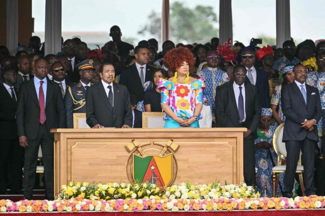 Cameroon's President Paul Biya (CL) and Cameroon's First Lady Chantal Biya (CR) attend the Holy Mass lead  by Pope Leo XIV at the Yaounde Ville Airport in Yaounde on the sixth day of an 11-day apostolic journey to Africa, on April 18, 2026. (Photo by Alberto PIZZOLI / AFP)