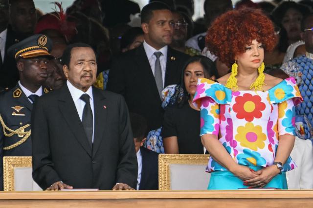 Cameroon's President Paul Biya (L) and Cameroon's First Lady Chantal Biya (R) attend the Holy Mass lead  by Pope Leo XIV at the Yaounde Ville Airport in Yaounde on the sixth day of an 11-day apostolic journey to Africa, on April 18, 2026. (Photo by Alberto PIZZOLI / AFP)