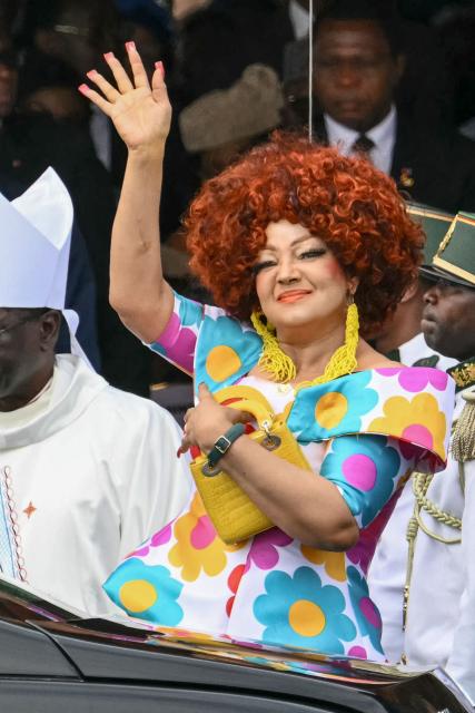 Cameroon's First Lady Chantal Biya waves as she arrive to attend the Holy Mass lead  by Pope Leo XIV at the Yaounde Ville Airport in Yaounde on the sixth day of an 11-day apostolic journey to Africa, on April 18, 2026. (Photo by Alberto PIZZOLI / AFP)