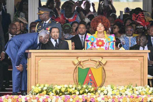 Cameroon's President Paul Biya (CL) and Cameroon's First Lady Chantal Biya (CR) attend the Holy Mass lead  by Pope Leo XIV at the Yaounde Ville Airport in Yaounde on the sixth day of an 11-day apostolic journey to Africa, on April 18, 2026. (Photo by Alberto PIZZOLI / AFP)