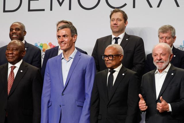 (From L bottom) South Africa's President Cyril Ramaphosa, Spain's Prime Minister Pedro Sanchez, Cape Verde's President Jose Maria Neves, Brazilian President Luiz Inacio Lula Da Silva, (From L top) Britain's Deputy Prime Minister and Justice Secretary David Lammy, and German Vice Chancellor and Finance Minister Lars Klingbeil pose for a family photo at a "Meeting in Defence of Democracy", a meeting of leftist leaders seeking to rally against the threat to democracy from the far right in Barcelona on April 18, 2026. The gathering comes as democratic institutions and values have faced growing threats around the globe from advancing authoritarian and far-right forces in the age of US President Donald Trump. Many of the participants will take part in the first edition of the so-called "Global Progressive Mobilisation" which will be held in the same venue. (Photo by Oscar DEL POZO / AFP)