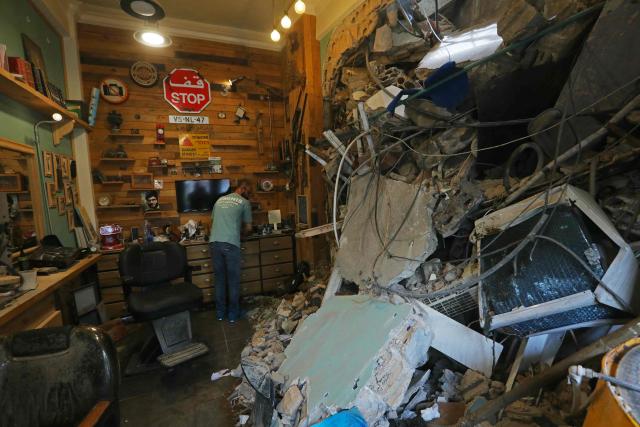 A shopkeeper clears the debris from his damaged shop upon his return to a neighborhood in Beirut’s southern suburbs, on April 18, 2026. Lebanese President Joseph Aoun said on April 17 that his country was on the verge of a "new phase" of "permanent agreements", after the 10-day ceasefire in the Israel-Hezbollah war went into force. Lebanon was drawn into the Middle East conflict on March 2 when Tehran-backed Hezbollah attacked Israel to avenge the death of Iranian supreme leader Ali Khamenei. (Photo by Ibrahim AMRO / AFP) / 