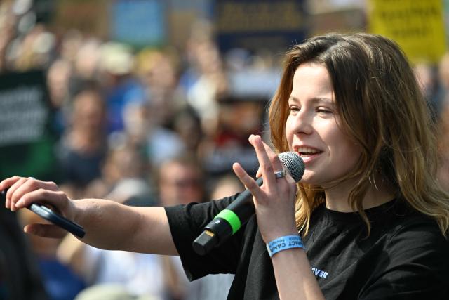 German climate activist Luisa Neubauer addresses activists and supporters of Fridays for Future, Campact and other groups as they demonstrate against the German government's energy policy, on April 18, 2026 in Berlin. Activists call for faster expansion of solar and wind energy, rapid development of distribution grids, storage and digitalization, a strong European clean energy industry, lower electricity taxes and cheaper power for heat pumps, as well as social support and tenant protection to ensure affordable, climate-friendly heating. (Photo by RALF HIRSCHBERGER / AFP)