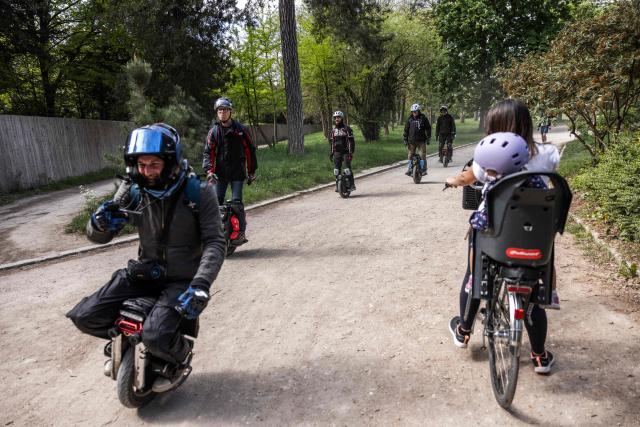 A group of people ride their Self-balancing electric unicycles (EUC) at the Bois de Vincennes park in Paris on April 18, 2026. (Photo by Behrouz MEHRI / AFP)