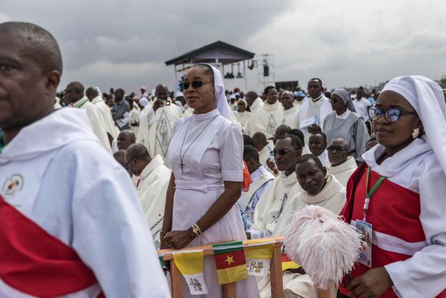 Faithfuls listen as Pope Leo XIV leads a Holy Mass at the Yaounde Ville Airport in Yaounde on the sixth day of an 11-day apostolic journey to Africa, on April 18, 2026. (Photo by PATRICK MEINHARDT / AFP)