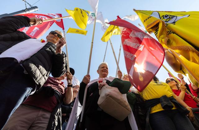 Protesters wave flags and placards during the demonstration "Croatia Together for Higher Wages and Pensions" organized by trade unions and pensioners against low incomes and the highest inflation in the eurozone, in downtown Zagreb on April 18, 2026. In March, Croatia’s annual inflation rate was the 4.89 percent, the highest in the eurozone, where it reached 2.6 percent. (Photo by MARKO PERKOV / AFP)