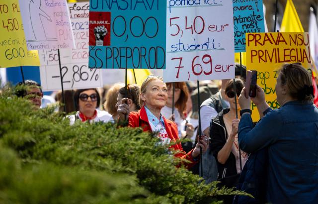 A protester holds a placard during the demonstration "Croatia Together for Higher Wages and Pensions" organized by trade unions and pensioners against low incomes and the highest inflation in the eurozone, in downtown Zagreb on April 18, 2026. In March, Croatia’s annual inflation rate was the 4.89 percent, the highest in the eurozone, where it reached 2.6 percent. (Photo by MARKO PERKOV / AFP)