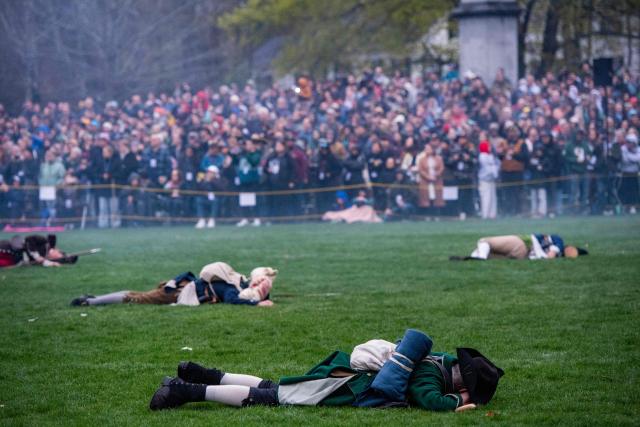 Members of the public watch a reenactment of the Battle of Lexington and Concord as part of Patriot's Day celebrations in Lexington, Massachusetts, on April 18, 2026. April 19, 2026 marks the 250th anniversary of the Battle of Lexington and Concord, the first major military actions between the British Army and the Colonial American militias during the American Revolutionary War. (Photo by Joseph Prezioso / AFP)