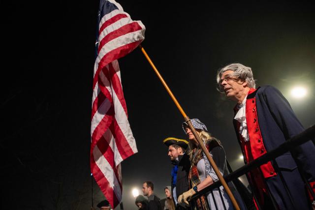 Members of the public watch a reenactment of the Battle of Lexington and Concord as part of Patriot's Day celebrations in Lexington, Massachusetts, on April 18, 2026. April 19, 2026 marks the 250th anniversary of the Battle of Lexington and Concord, the first major military actions between the British Army and the Colonial American militias during the American Revolutionary War. (Photo by Joseph Prezioso / AFP)