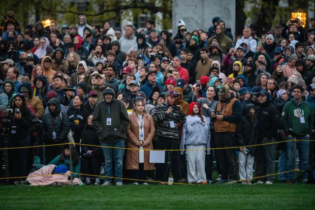 Members of the public watch a reenactment of the Battle of Lexington and Concord as part of Patriot's Day celebrations in Lexington, Massachusetts, on April 18, 2026. April 19, 2026 marks the 250th anniversary of the Battle of Lexington and Concord, the first major military actions between the British Army and the Colonial American militias during the American Revolutionary War. (Photo by Joseph Prezioso / AFP)