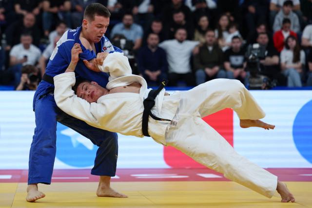 Finland's Eetu Ihanamaki (white) and Serbia's Mihajlo Simin compete in the men's under 81 kg category bronze medal bout at the Judo European Senior Championships 2026 in Tbilisi on April 18, 2026. (Photo by Giorgi ARJEVANIDZE / AFP)