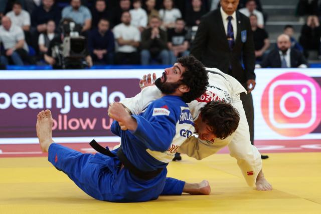 Russia's Timur Arbuzov (white) and Georgia's Tato Grigalashvili compete in the men's under 81 kg category gold medal bout at the Judo European Senior Championships 2026 in Tbilisi on April 18, 2026. (Photo by Giorgi ARJEVANIDZE / AFP)