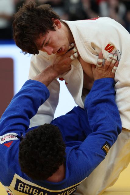 Russia's Timur Arbuzov (white) and Georgia's Tato Grigalashvili compete in the men's under 81 kg category gold medal bout at the Judo European Senior Championships 2026 in Tbilisi on April 18, 2026. (Photo by Giorgi ARJEVANIDZE / AFP)