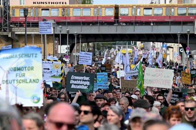 Activists and supporters of Fridays for Future, Campact and others take part in a demonstration against the German government's energy policy, on April 18, 2026 in Berlin. Activists call for faster expansion of solar and wind energy, rapid development of distribution grids, storage and digitalization, a strong European clean energy industry, lower electricity taxes and cheaper power for heat pumps, as well as social support and tenant protection to ensure affordable, climate-friendly heating. (Photo by RALF HIRSCHBERGER / AFP)
