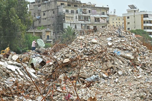 A resident inspects the rubble of destroyed buildings upon his arrival back to the southern Lebanese city of Nabatieh on April 18, 2026. Lebanese President Joseph Aoun said on April 17 that his country was on the verge of a "new phase" of "permanent agreements", after the 10-day ceasefire in the Israel-Hezbollah war went into force. Lebanon was drawn into the Middle East conflict on March 2 when Tehran-backed Hezbollah attacked Israel to avenge the death of Iranian supreme leader Ali Khamenei. (Photo by FADEL itani / AFP)