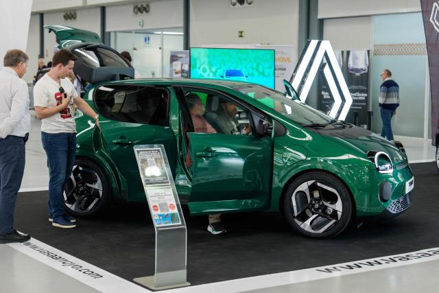 Visitors look at Renault Twingo E-Tech car at the Retro Auto Moto Valladolid Show during the celebration of Renault FASA's 75th anniversary in Valladolid, Spain on April 18, 2026. (Photo by CESAR MANSO / AFP)