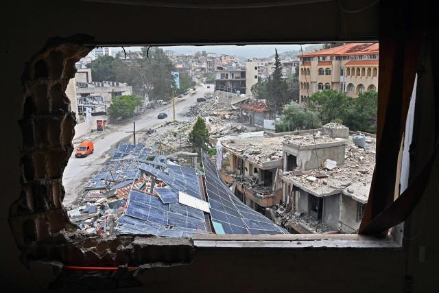 Displaced residents drive past destroyed buildings as they return back to the southern Lebanese city of Nabatieh on April 18, 2026. Lebanese President Joseph Aoun said on April 17 that his country was on the verge of a "new phase" of "permanent agreements", after the 10-day ceasefire in the Israel-Hezbollah war went into force. Lebanon was drawn into the Middle East conflict on March 2 when Tehran-backed Hezbollah attacked Israel to avenge the death of Iranian supreme leader Ali Khamenei. (Photo by FADEL itani / AFP)