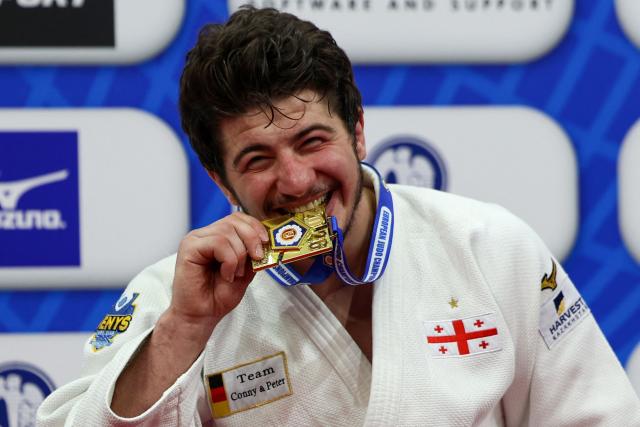 Gold medallist Georgia's Luka Maisuradze celebrates on the podium for the men's under 90 kg category event at the Judo European Senior Championships 2026 in Tbilisi on April 18, 2026. (Photo by Giorgi ARJEVANIDZE / AFP)
