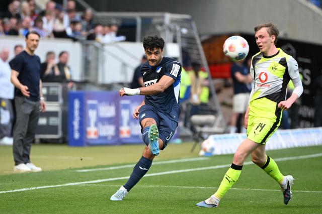 Hoffenheim's Turkish defender #05 Ozan Kabak and Dortmund's German forward #14 Maximilian Beier vie for the ball during the German first division Bundesliga football match between TSG 1899 Hoffenheim and BVB Borussia Dortmund in Sinsheim, southwestern Germany on April 18, 2026. (Photo by Uli Deck / AFP) / DFL REGULATIONS PROHIBIT ANY USE OF PHOTOGRAPHS AS IMAGE SEQUENCES AND/OR QUASI-VIDEO