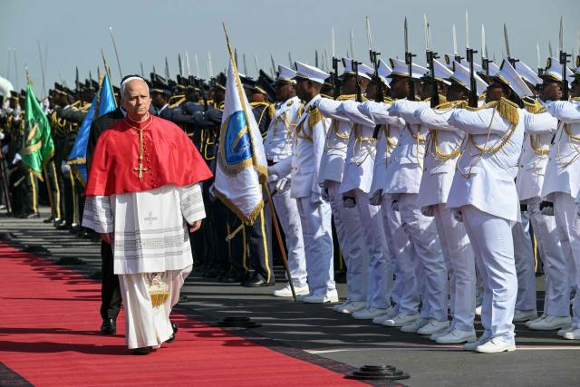 Pope Leo XIV (L) arrives at the "4 de Fevereiro" Luanda International Airport in Luanda on the sixth day of an 11-day apostolic journey to Africa, on April 18, 2026. (Photo by Alberto PIZZOLI / AFP)