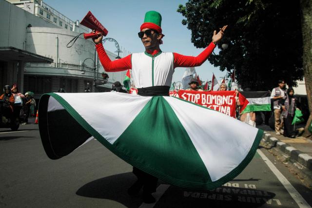 A Sufi dancer joins a rally in support of Palestine, Lebanon and Iran as part of commemorations marking the 71st anniversary of the Asian-African Conference in Bandung, West Java on April 18, 2026. (Photo by Timur Matahari / AFP)