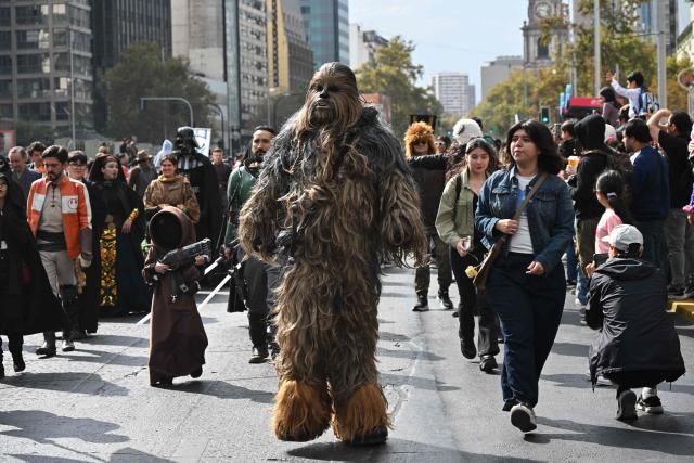 Fans wearing costumes from the Star Wars films take part in the Desfile de las Galaxias 2026 in Santiago on April 18, 2026. (Photo by RODRIGO ARANGUA / AFP)