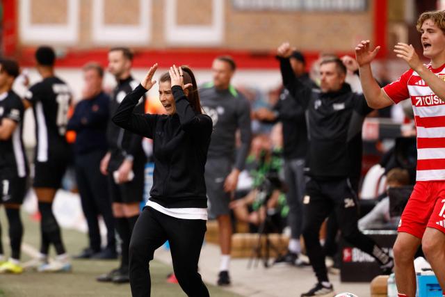 Union Berlin's German head coach Marie-Louise Eta reacts from the sidelines during the German first division Bundesliga football match between Union Berlin and VfL Wolfsburg in Berlin, Germany, on April 18, 2026. (Photo by Odd ANDERSEN / AFP) / DFL REGULATIONS PROHIBIT ANY USE OF PHOTOGRAPHS AS IMAGE SEQUENCES AND/OR QUASI-VIDEO