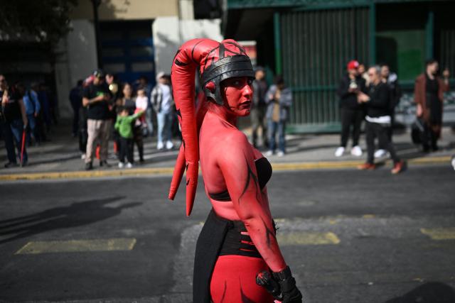 A fan wearing a costume from the Star Wars films takes part in the Desfile de las Galaxias 2026 in Santiago on April 18, 2026. (Photo by RODRIGO ARANGUA / AFP)
