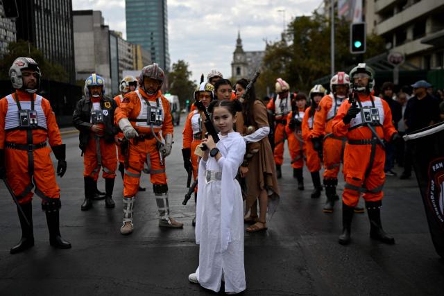 Fans wearing costumes from the Star Wars films take part in the Desfile de las Galaxias 2026 in Santiago on April 18, 2026. (Photo by RODRIGO ARANGUA / AFP)