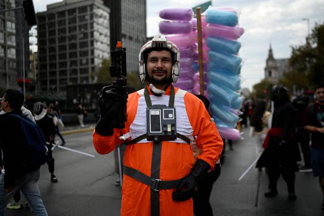 A fan wearing a costume from the Star Wars films takes part in the Desfile de las Galaxias 2026 in Santiago on April 18, 2026. (Photo by RODRIGO ARANGUA / AFP)