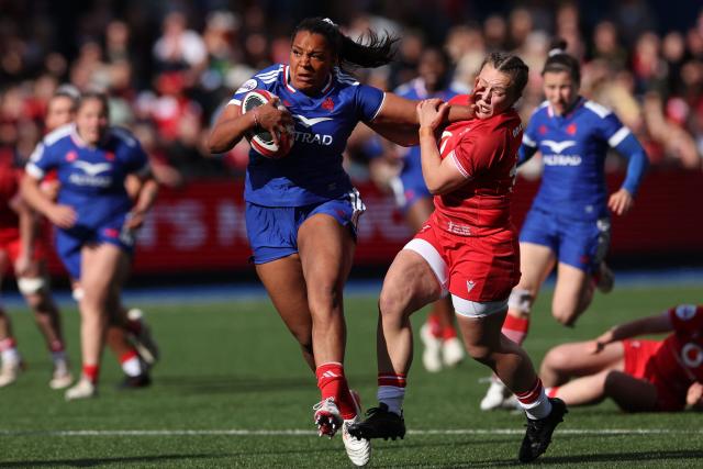 France's Ambre Mwayembe hands off Wales' fly-half Lleucu George during the Women's Six Nations international rugby union match between Wales and France  at the Cardiff Arms Park, in Cardiff, southern Wales on April 18, 2026. (Photo by Adrian Dennis / AFP)