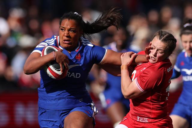 France's Ambre Mwayembe hands off Wales' fly-half Lleucu George during the Women's Six Nations international rugby union match between Wales and France  at the Cardiff Arms Park, in Cardiff, southern Wales on April 18, 2026. (Photo by Adrian Dennis / AFP)