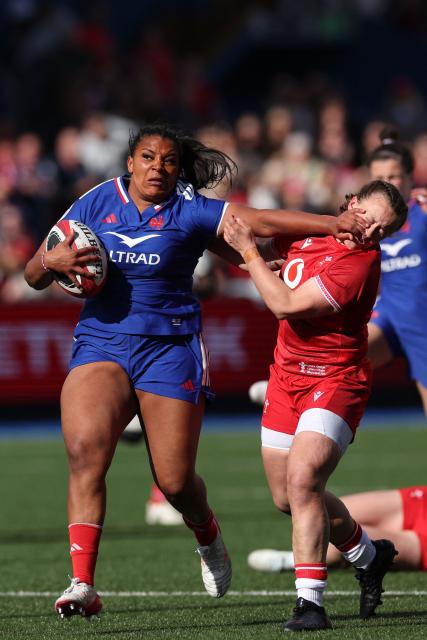 France's Ambre Mwayembe hands off Wales' fly-half Lleucu George during the Women's Six Nations international rugby union match between Wales and France  at the Cardiff Arms Park, in Cardiff, southern Wales on April 18, 2026. (Photo by Adrian Dennis / AFP)