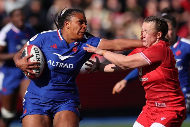 France's Ambre Mwayembe hands off Wales' fly-half Lleucu George during the Women's Six Nations international rugby union match between Wales and France  at the Cardiff Arms Park, in Cardiff, southern Wales on April 18, 2026. (Photo by Adrian Dennis / AFP)