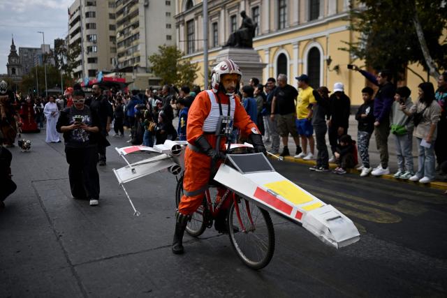 A fan wearing a costume from the Star Wars films takes part in the Desfile de las Galaxias 2026 in Santiago on April 18, 2026. (Photo by RODRIGO ARANGUA / AFP)