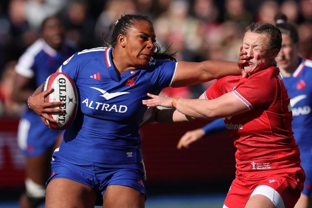 France's Ambre Mwayembe hands off Wales' fly-half Lleucu George during the Women's Six Nations international rugby union match between Wales and France  at the Cardiff Arms Park, in Cardiff, southern Wales on April 18, 2026. (Photo by Adrian Dennis / AFP)